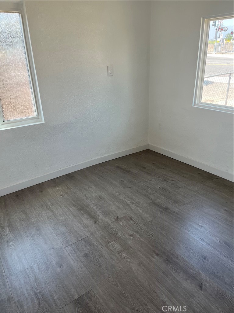 9325 East 8th Street, Unit A Rancho Cucamonga, CA 91730 - Photo 2 of 5 an empty room with wooden floor and windows