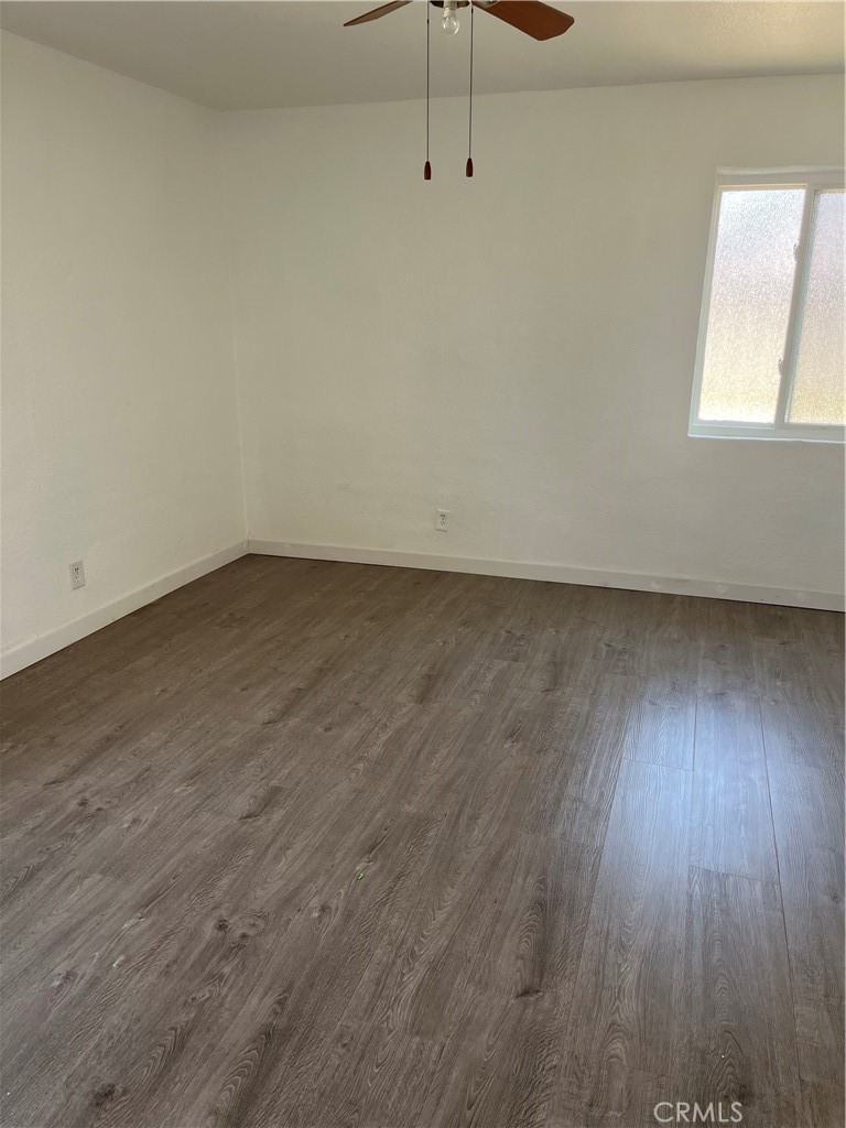 9325 East 8th Street, Unit A Rancho Cucamonga, CA 91730 - Photo 4 of 5 an empty room with wooden floor and windows