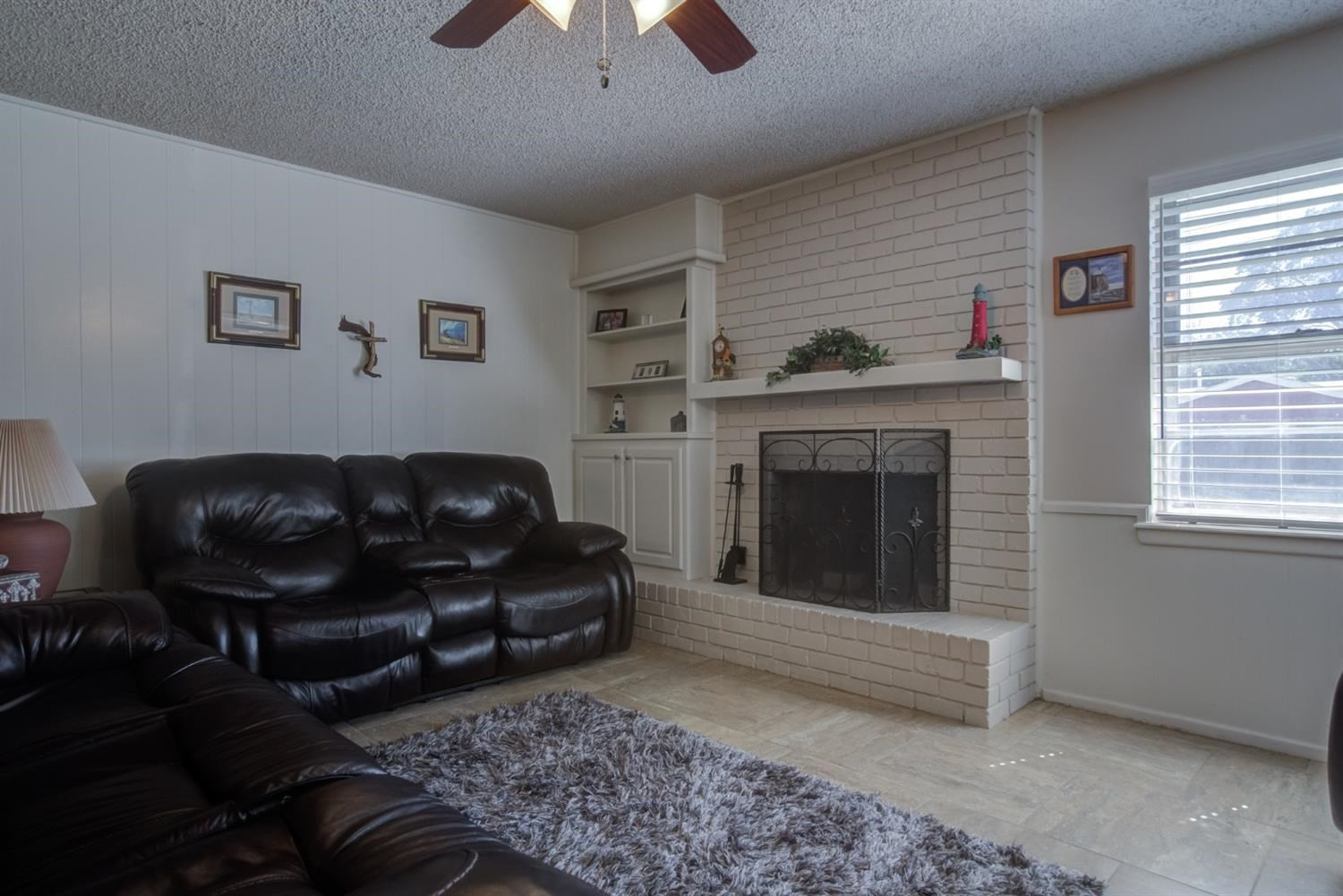 5427 46th Street Lubbock, TX 79414 - Photo 11 of 38 a living room with furniture and a fireplace