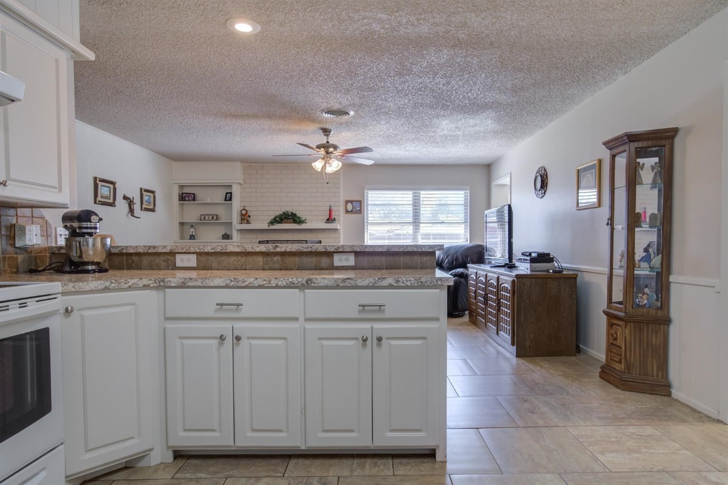 5427 46th Street Lubbock, TX 79414 - Photo 15 of 38 a kitchen with cabinets and window