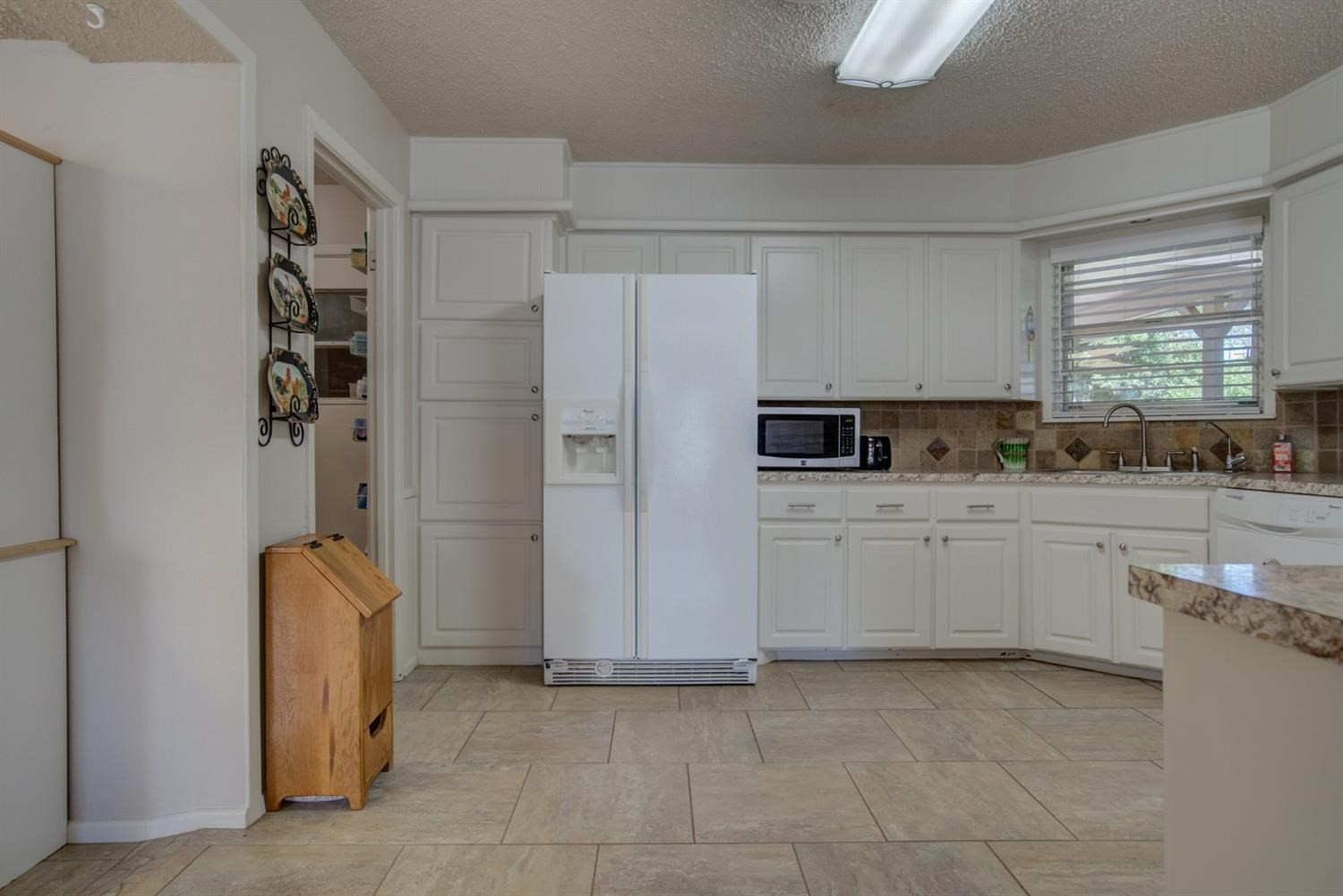 5427 46th Street Lubbock, TX 79414 - Photo 19 of 38 a kitchen with stainless steel appliances a refrigerator sink and cabinets