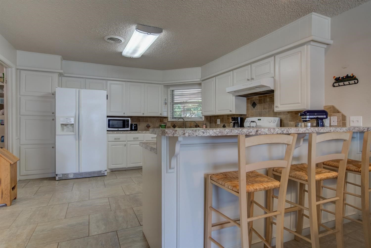 5427 46th Street Lubbock, TX 79414 - Photo 20 of 38 a kitchen with stainless steel appliances granite countertop a refrigerator sink and cabinets