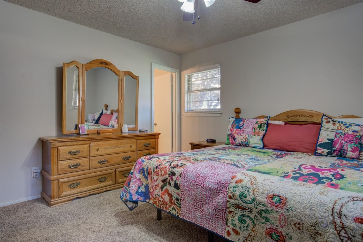 5427 46th Street Lubbock, TX 79414 - Photo 27 of 38 a bedroom with a bed and a dresser