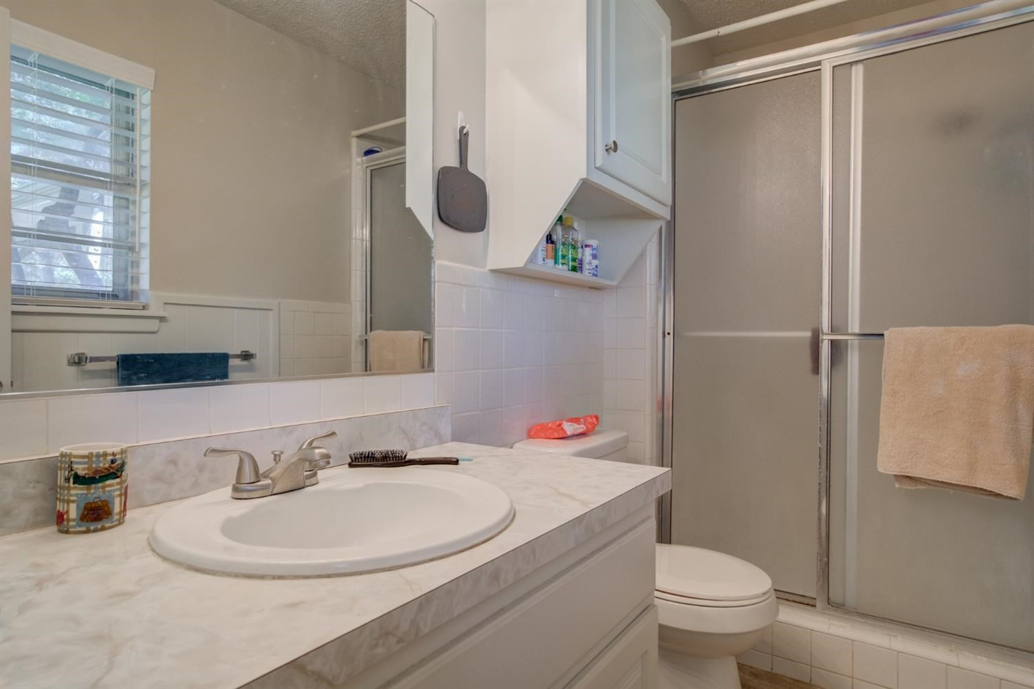 5427 46th Street Lubbock, TX 79414 - Photo 29 of 38 a bathroom with a sink toilet and shower