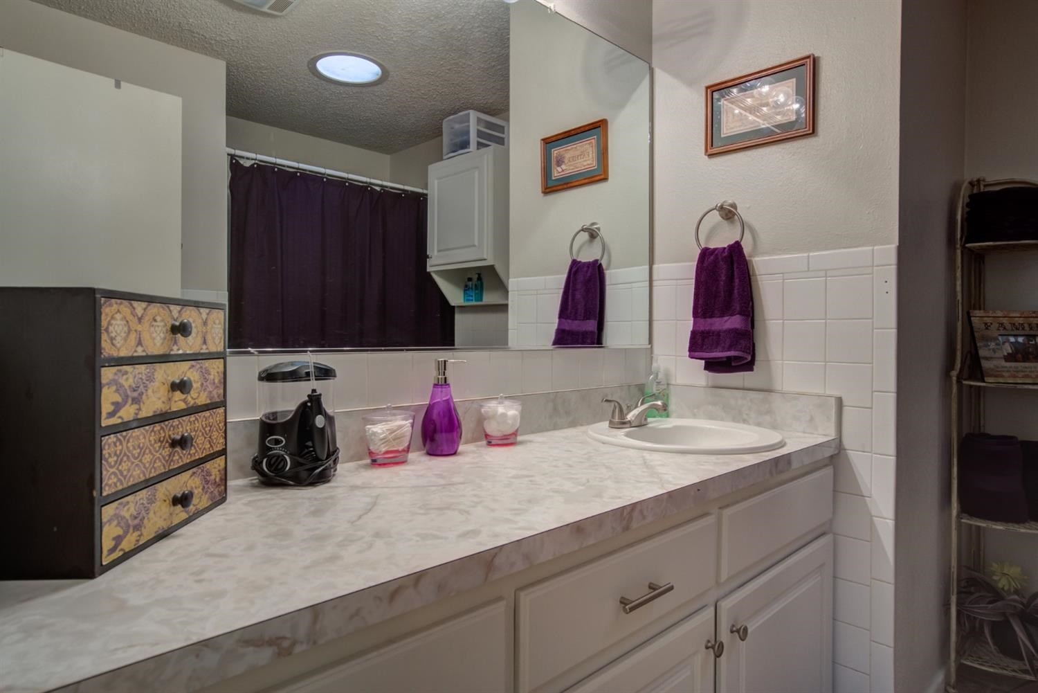 5427 46th Street Lubbock, TX 79414 - Photo 34 of 38 a bathroom with a sink and a mirror