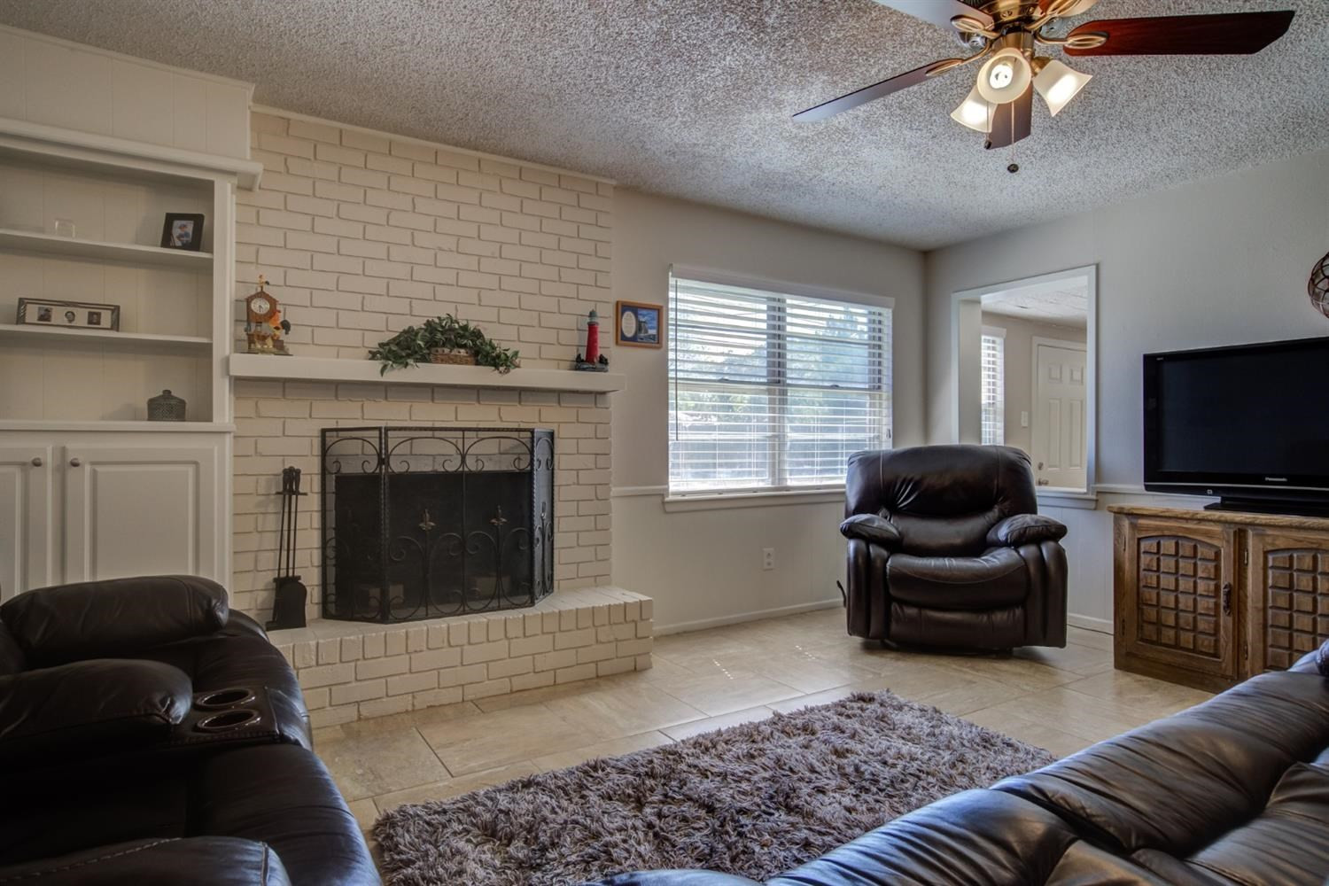 5427 46th Street Lubbock, TX 79414 - Photo 8 of 38 a living room with furniture and a fireplace