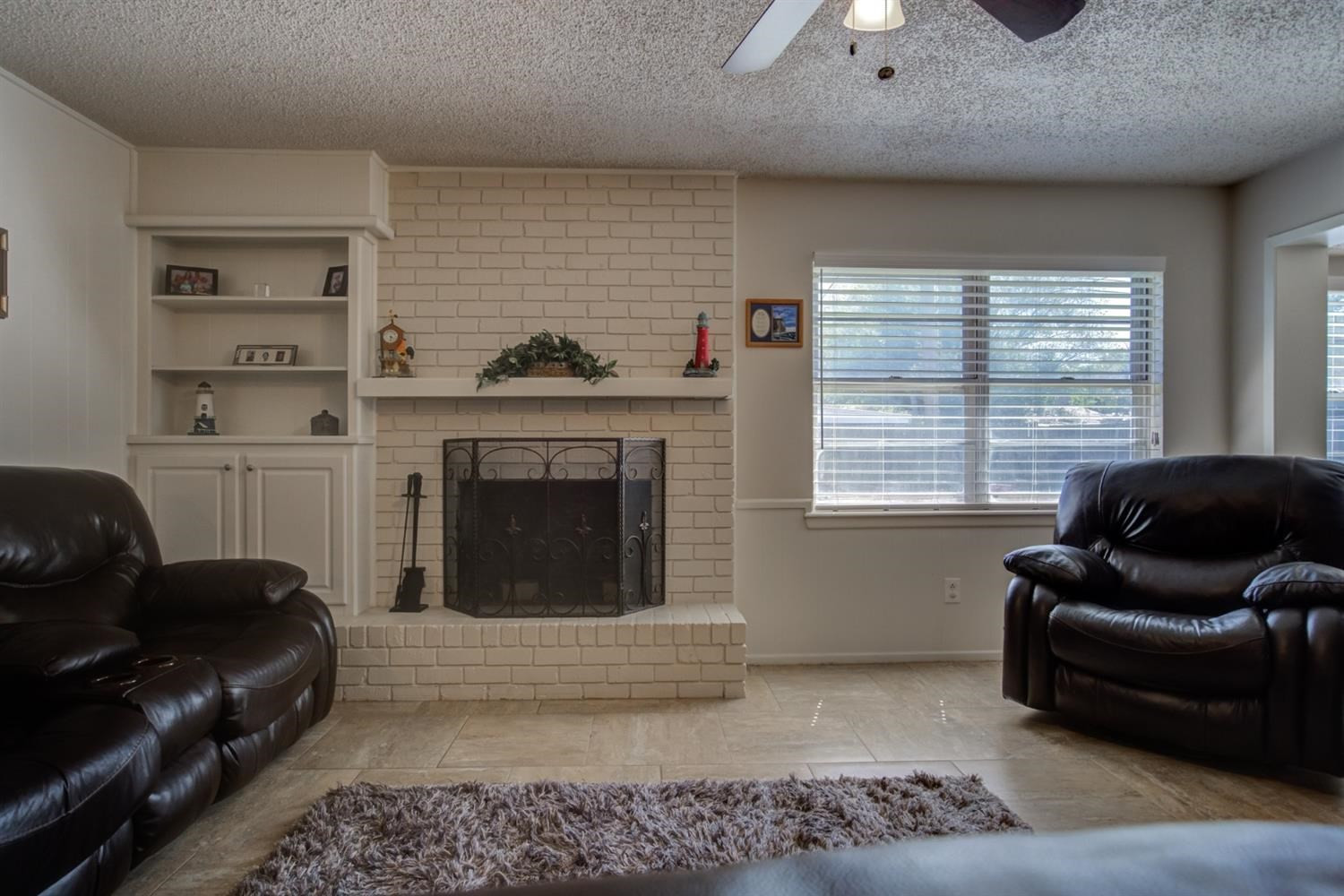 5427 46th Street Lubbock, TX 79414 - Photo 9 of 38 a living room with furniture and a fireplace