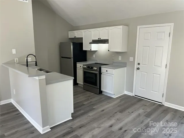 a kitchen with wooden cabinets and stainless steel appliances