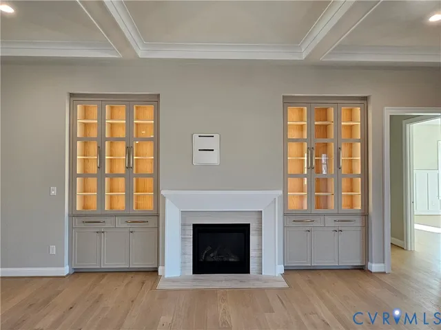 a view of an empty room with a fireplace and a window
