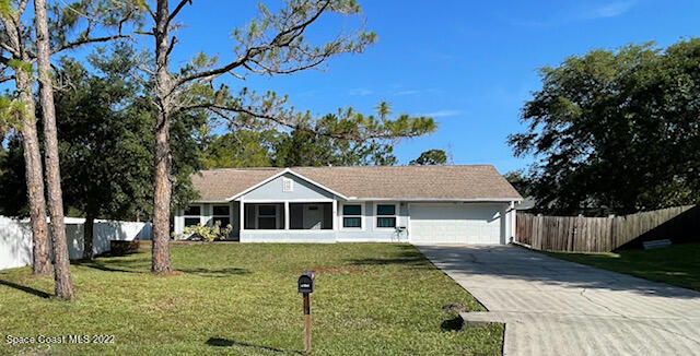 1309 Rascal Street Southeast Palm Bay, FL 32909 - Photo 1 of 17 a front view of a house with a yard
