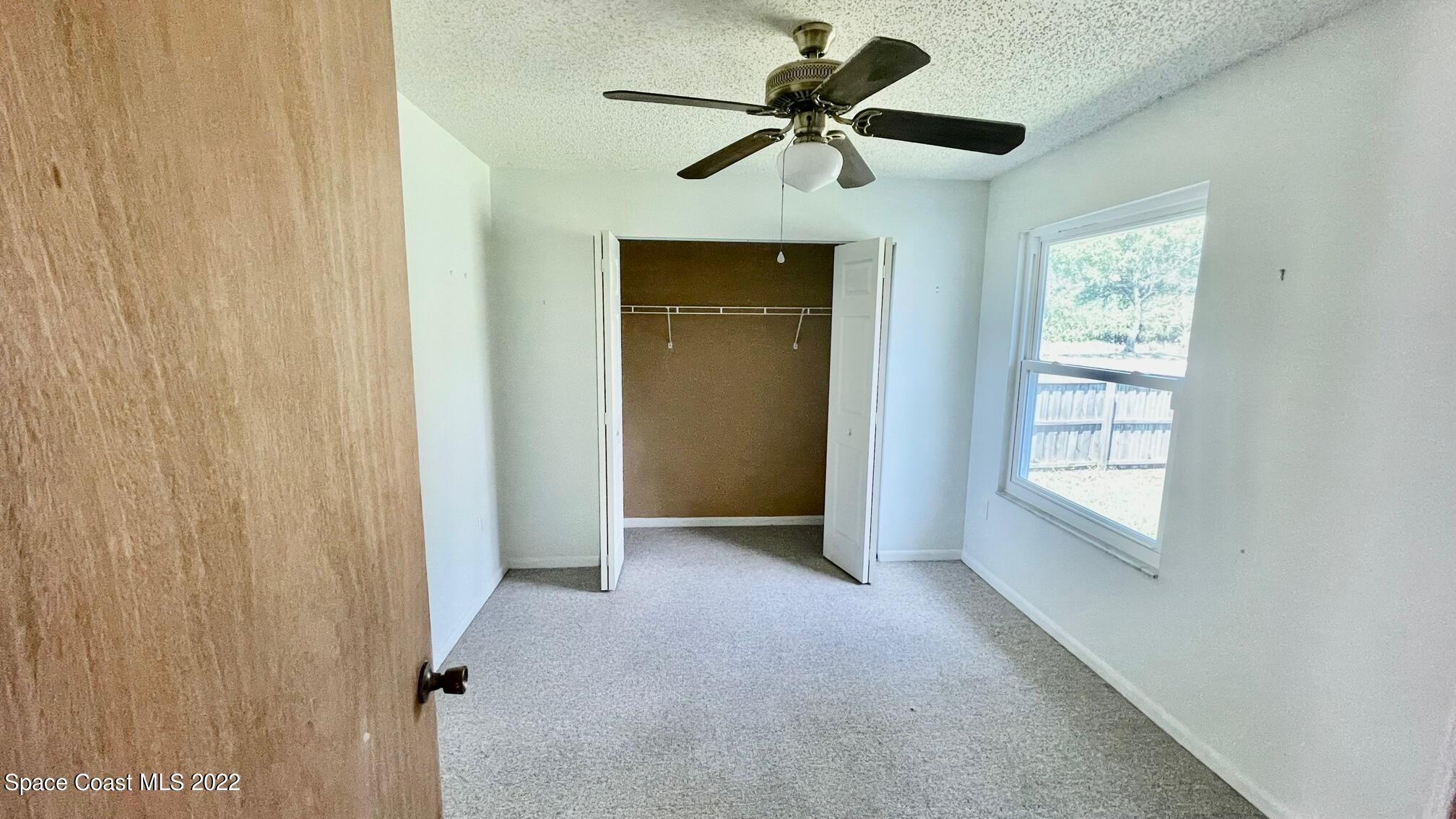 1309 Rascal Street Southeast Palm Bay, FL 32909 - Photo 13 of 17 a view of room with ceiling fan