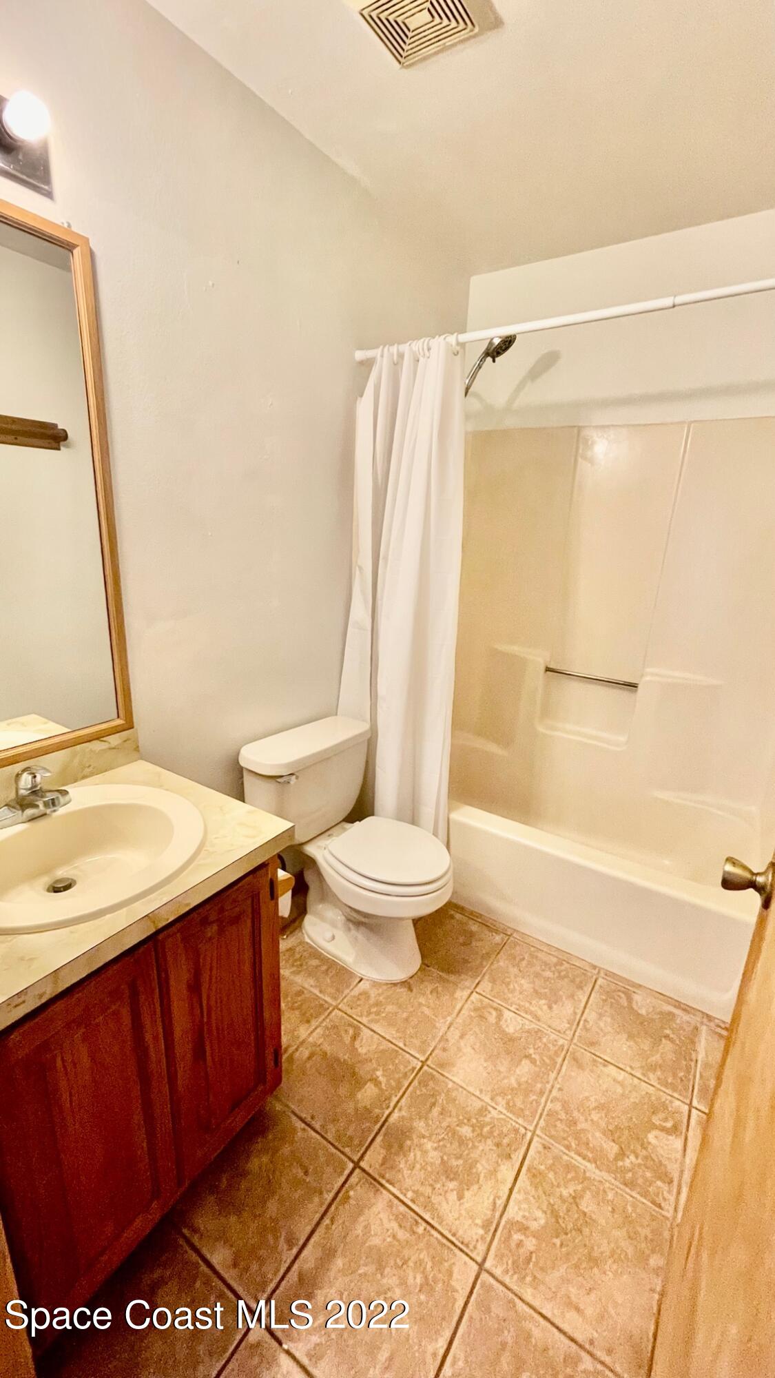 1309 Rascal Street Southeast Palm Bay, FL 32909 - Photo 14 of 17 a bathroom with a sink and a mirror