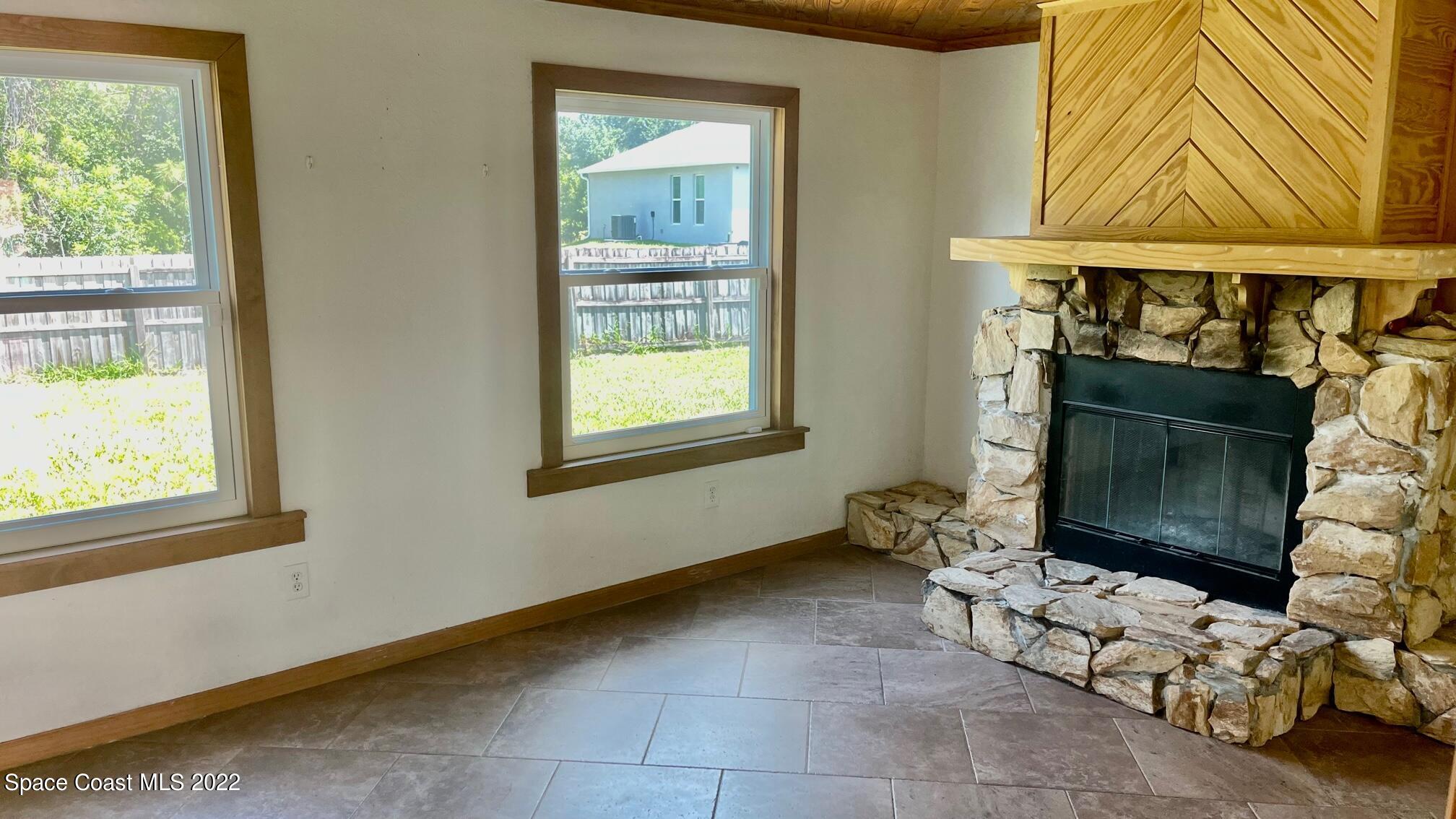 1309 Rascal Street Southeast Palm Bay, FL 32909 - Photo 6 of 17 a living room with furniture and a fireplace