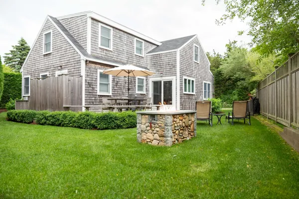a front view of a house with a garden and patio