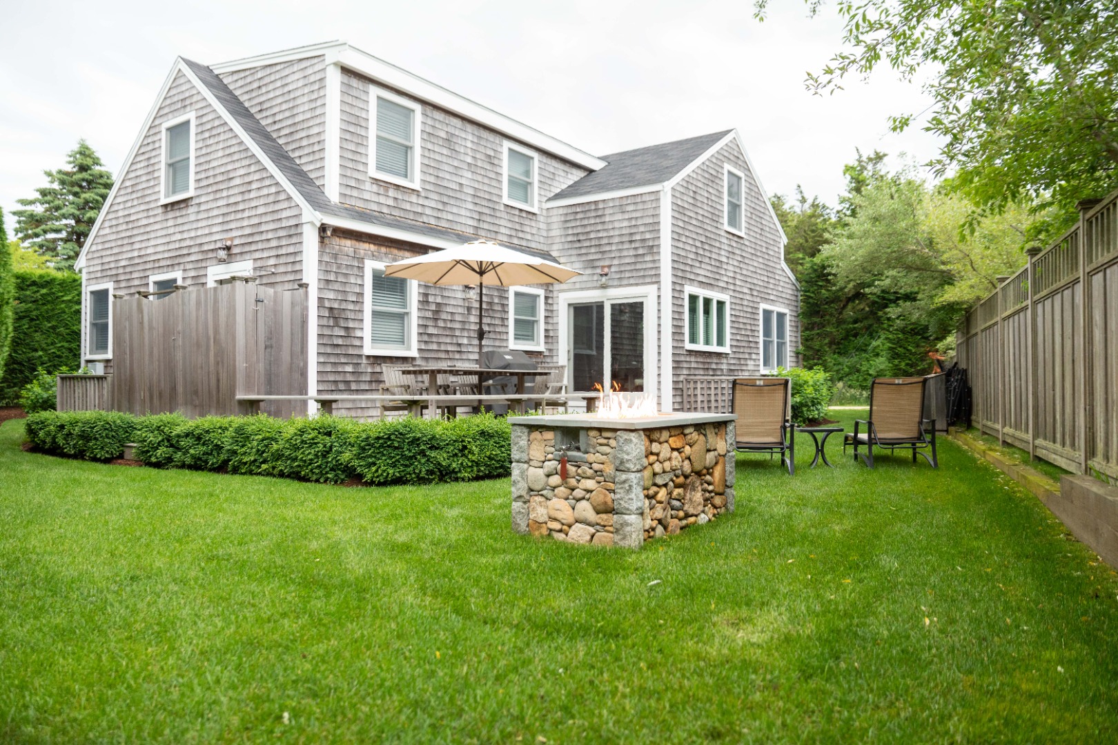 10 Pilgrim Road Nantucket, MA 02554 - Photo 1 of 65 a front view of a house with a garden and patio