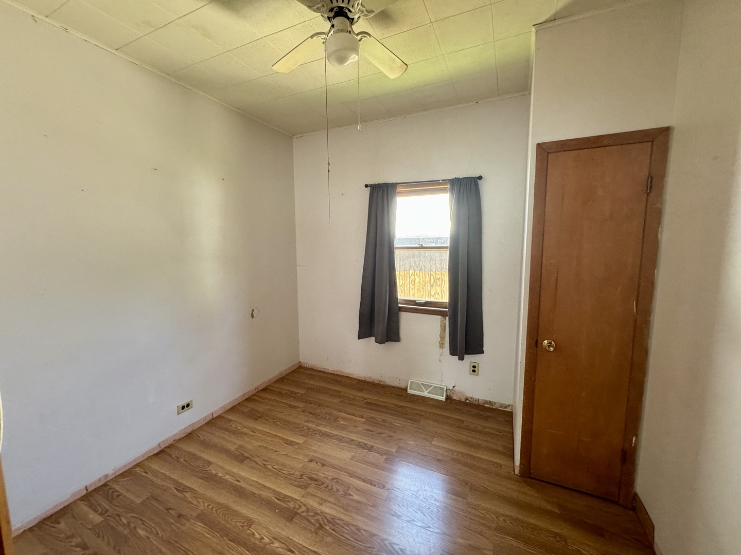 221 East 1st Street Spring Valley, IL 61362 - Photo 13 of 19 an empty room with wooden floor fan and windows