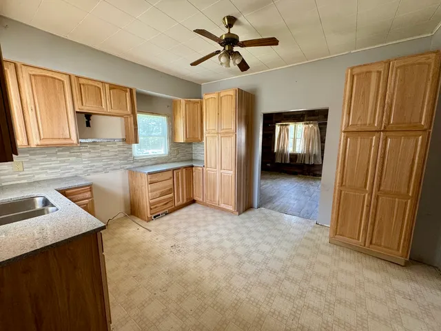 a kitchen with granite countertop stainless steel appliances a sink and a refrigerator