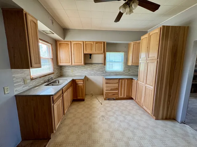 a kitchen with stainless steel appliances granite countertop a refrigerator a sink dishwasher and a stove