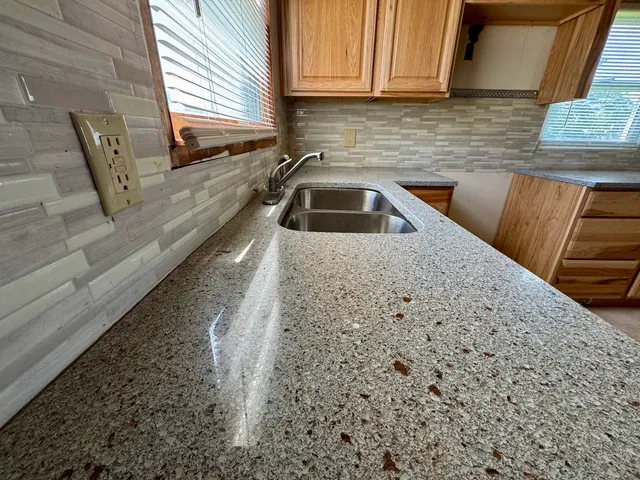 a kitchen with a sink a stove and cabinets