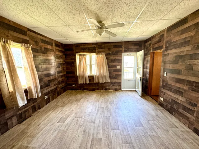 a view of a room with wooden floor and closet