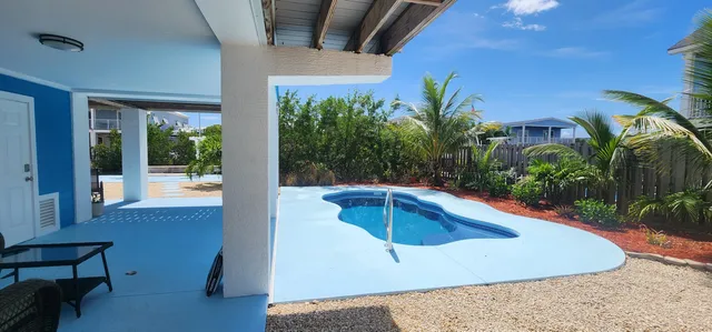 a view of a swimming pool with an outdoor seating