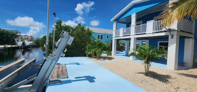 a front view of a house with lake view and a fountain