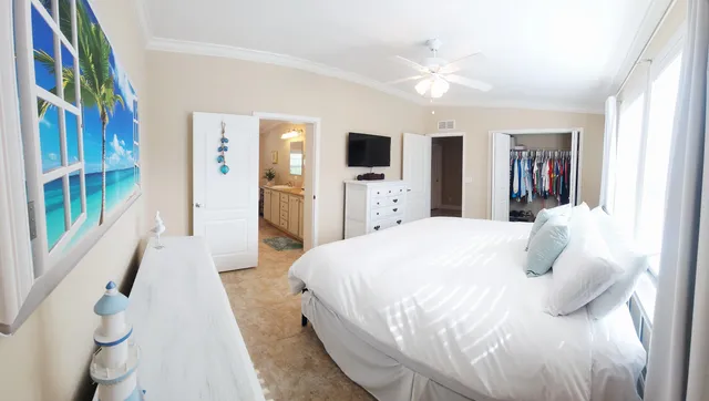 a bedroom with a large bed and a flat screen tv