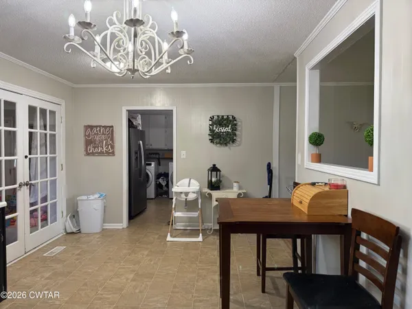 a view of a dining room with furniture and chandelier