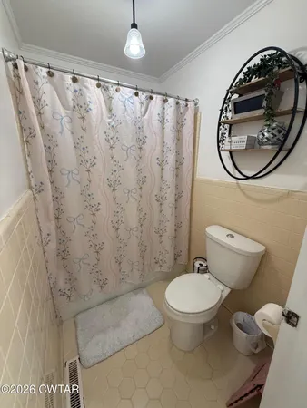 a bathroom with a toilet and a sink