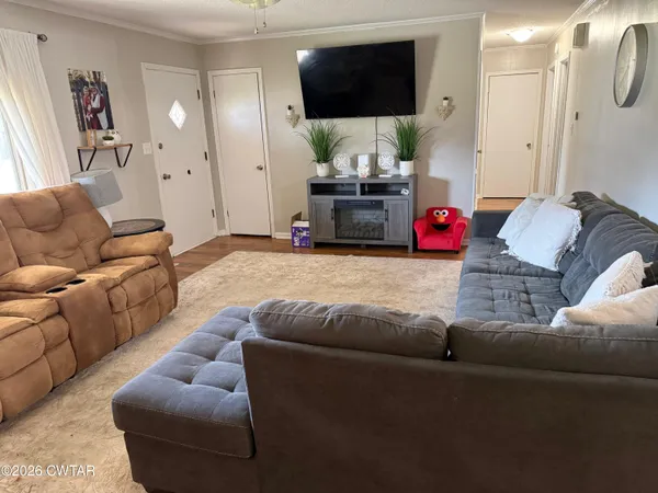 a living room with furniture and a flat screen tv