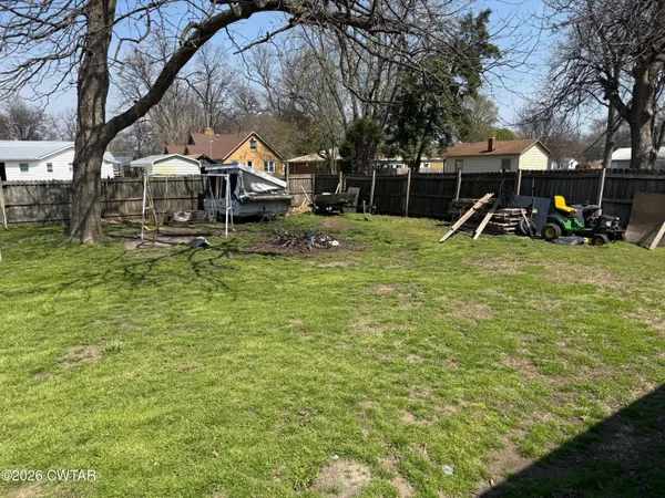 a view of swimming pool with sitting area and garden