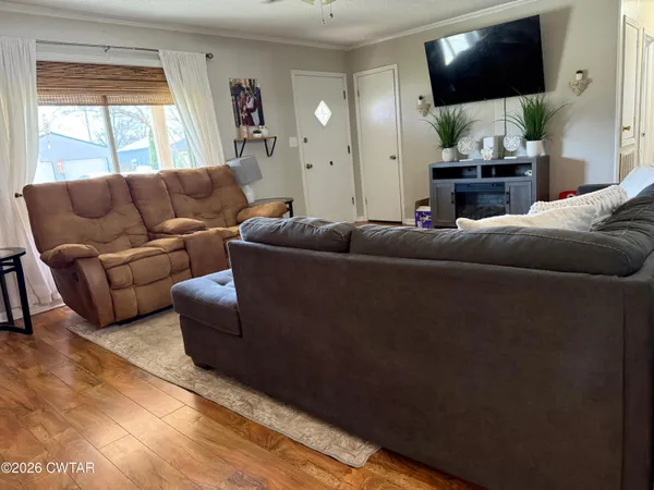 a living room with furniture and a flat screen tv