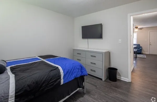 a bedroom with a bed and a flat screen tv