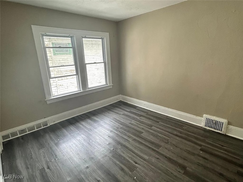 13902 Coit Road Cleveland, OH 44110 - Photo 13 of 17 Unfurnished room featuring dark hardwood / wood-style floors
