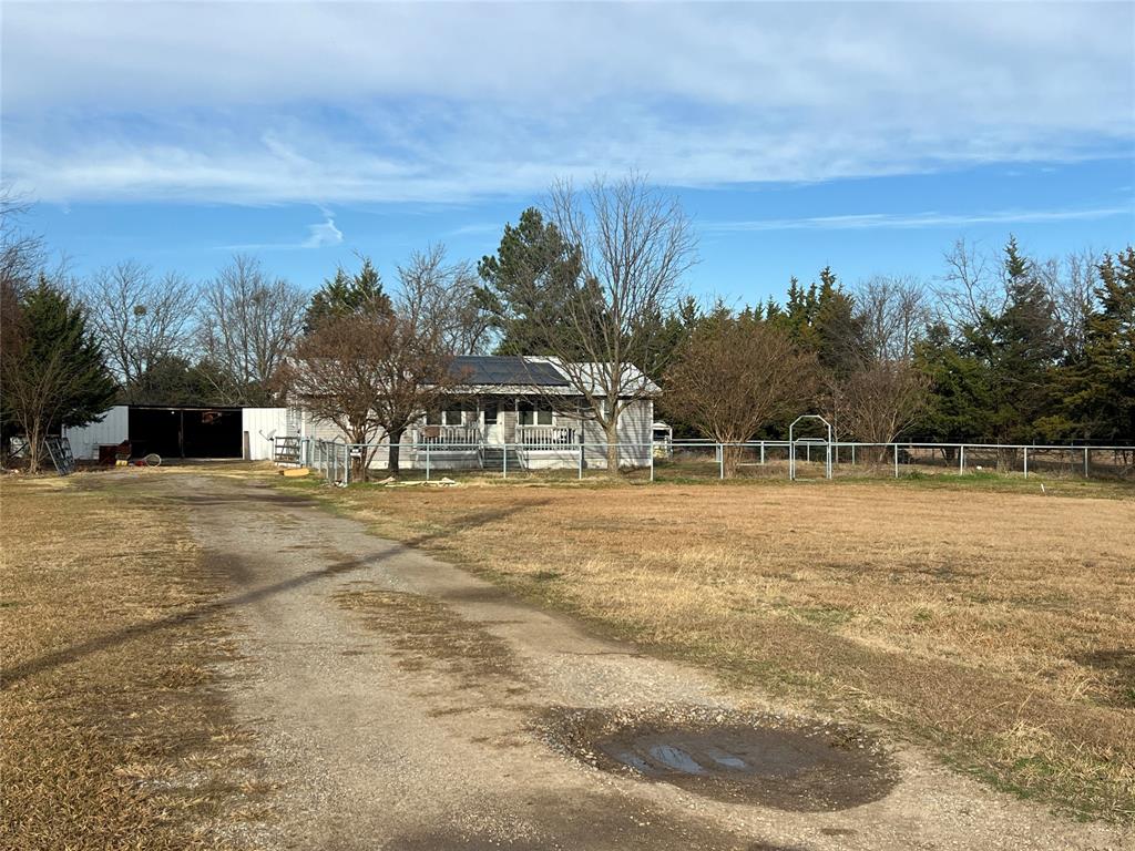 a view of swimming pool with outdoor seating and trees in the background