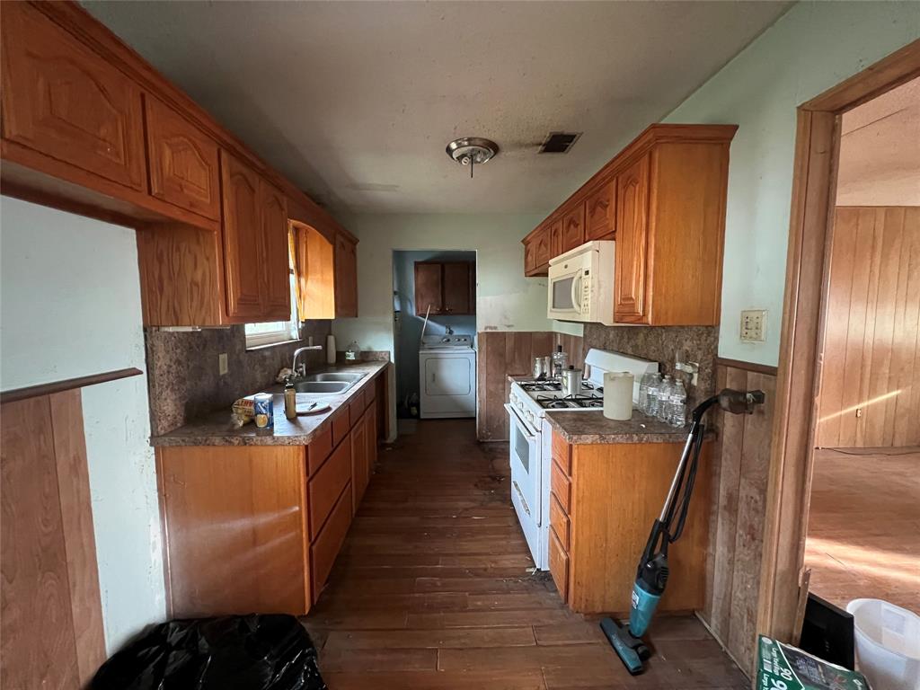 1335 Washburn Road North Bells, TX 75414 - Photo 7 of 12 a kitchen with stainless steel appliances granite countertop a refrigerator a stove top oven a sink and dishwasher