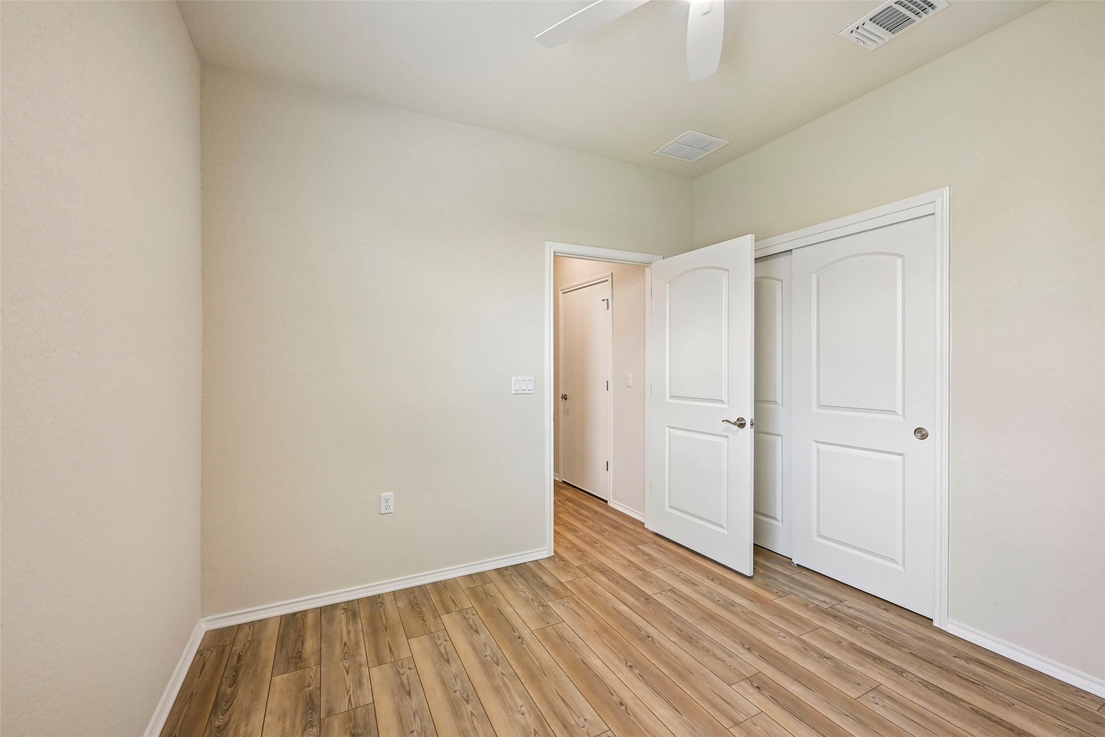 401 Yorktown Street Georgetown, TX 78633 - Photo 28 of 38 Room featuring wood-finish flooring, light neutral wall paint, and white trim