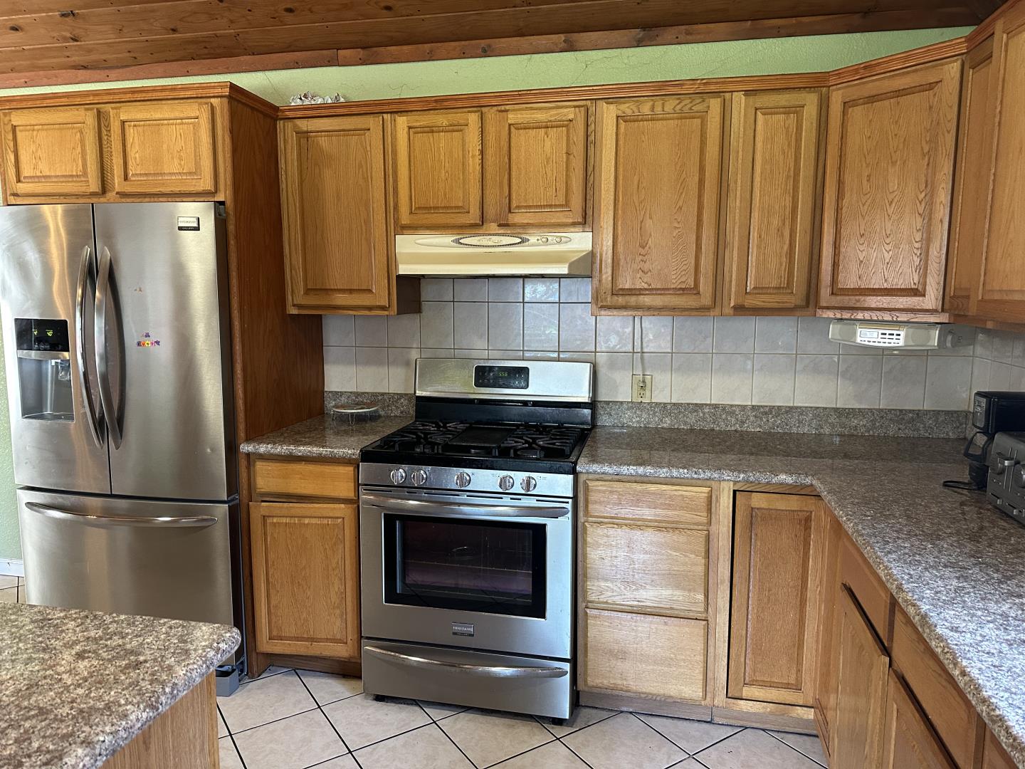 544 Sequoia Road Hayward, CA 94541 - Photo 12 of 34 a kitchen with granite countertop a refrigerator stove and cabinets