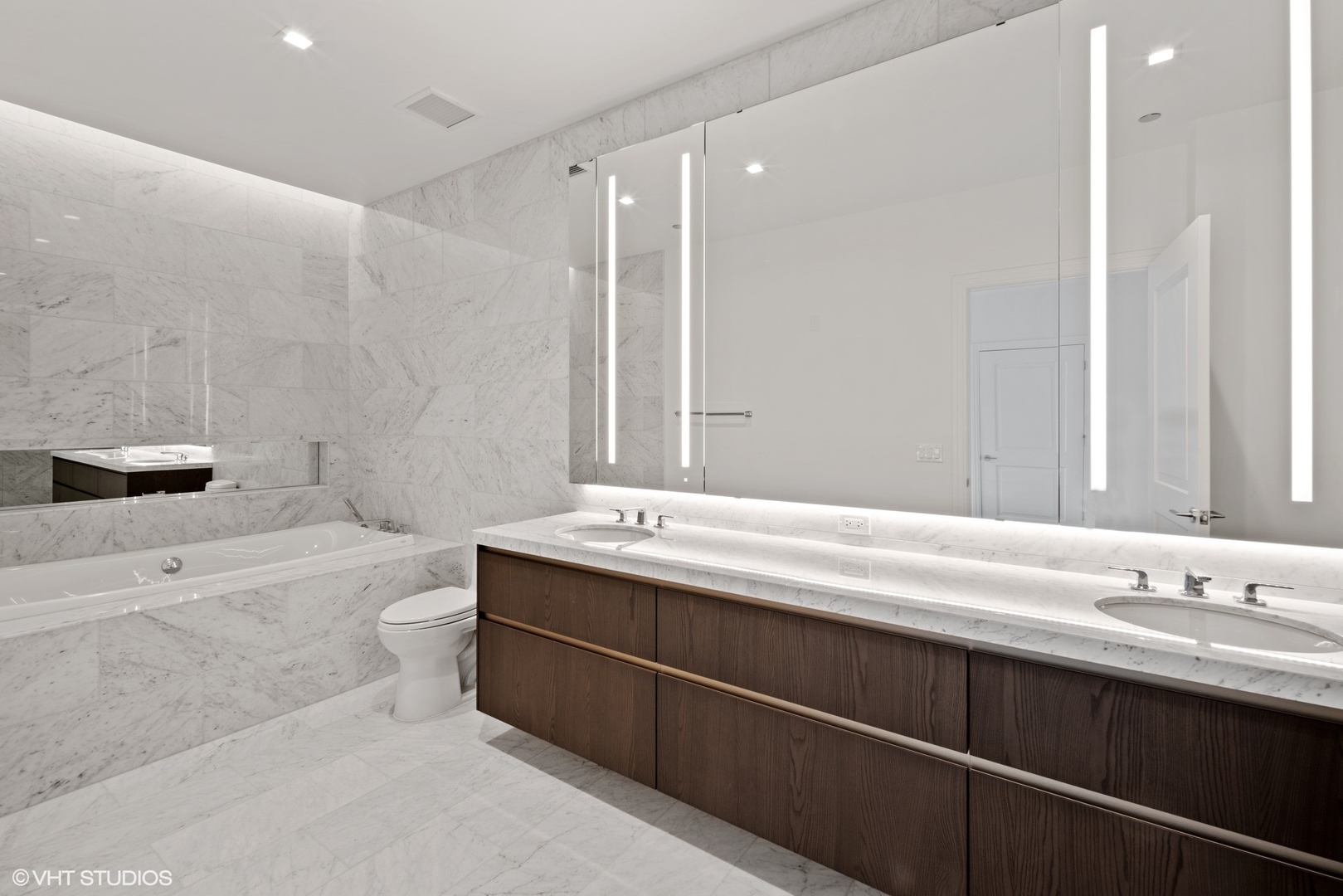 363 East Wacker Drive, Unit 1802 Chicago, IL 60601 - Photo 12 of 15 a bathroom with a sink a toilet and shower