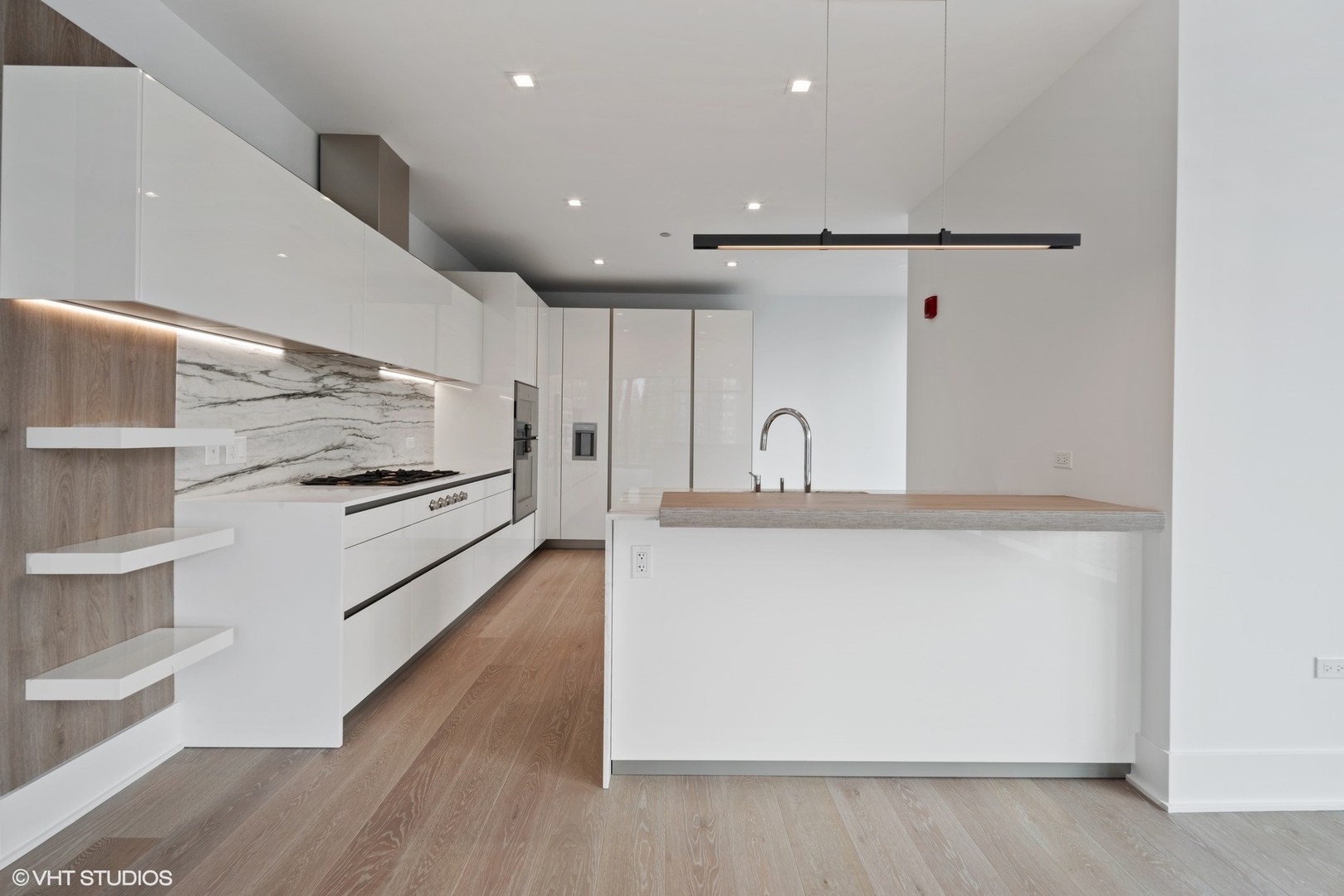 363 East Wacker Drive, Unit 1802 Chicago, IL 60601 - Photo 3 of 15 a kitchen with stainless steel appliances a refrigerator and microwave