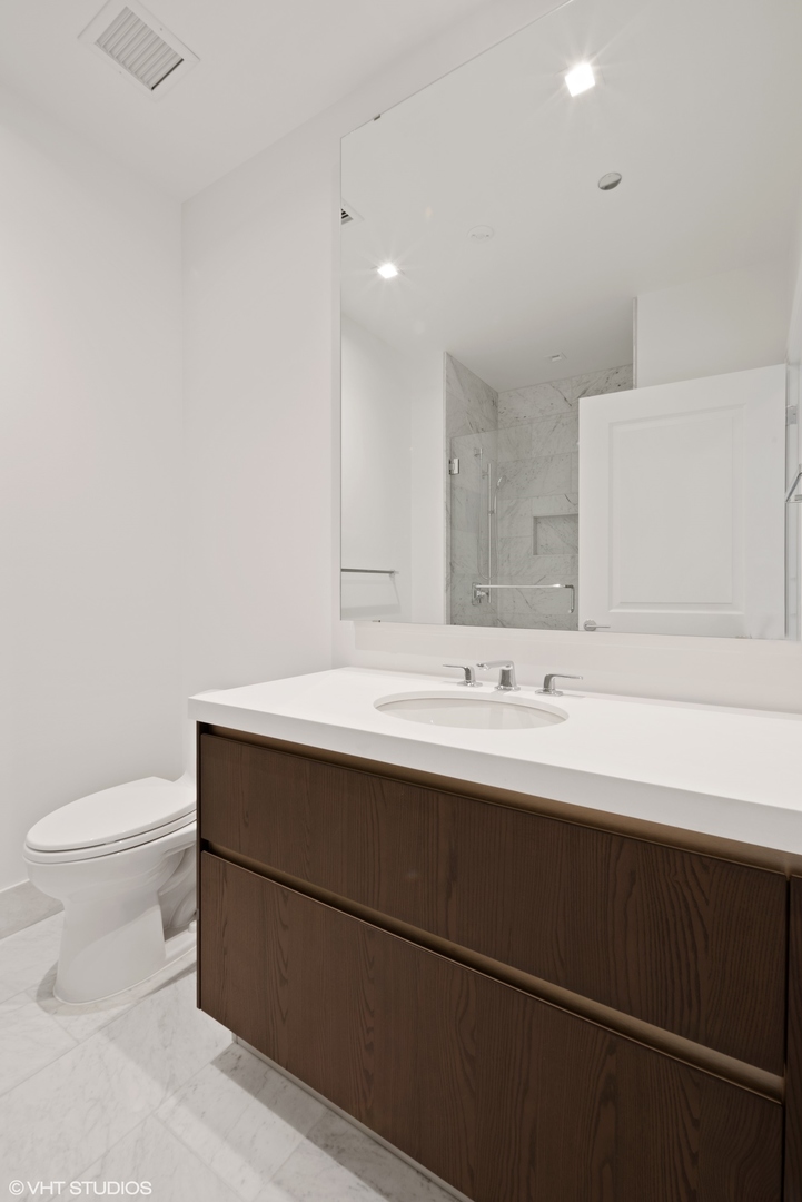 363 East Wacker Drive, Unit 1802 Chicago, IL 60601 - Photo 7 of 15 a bathroom with a sink and a toilet