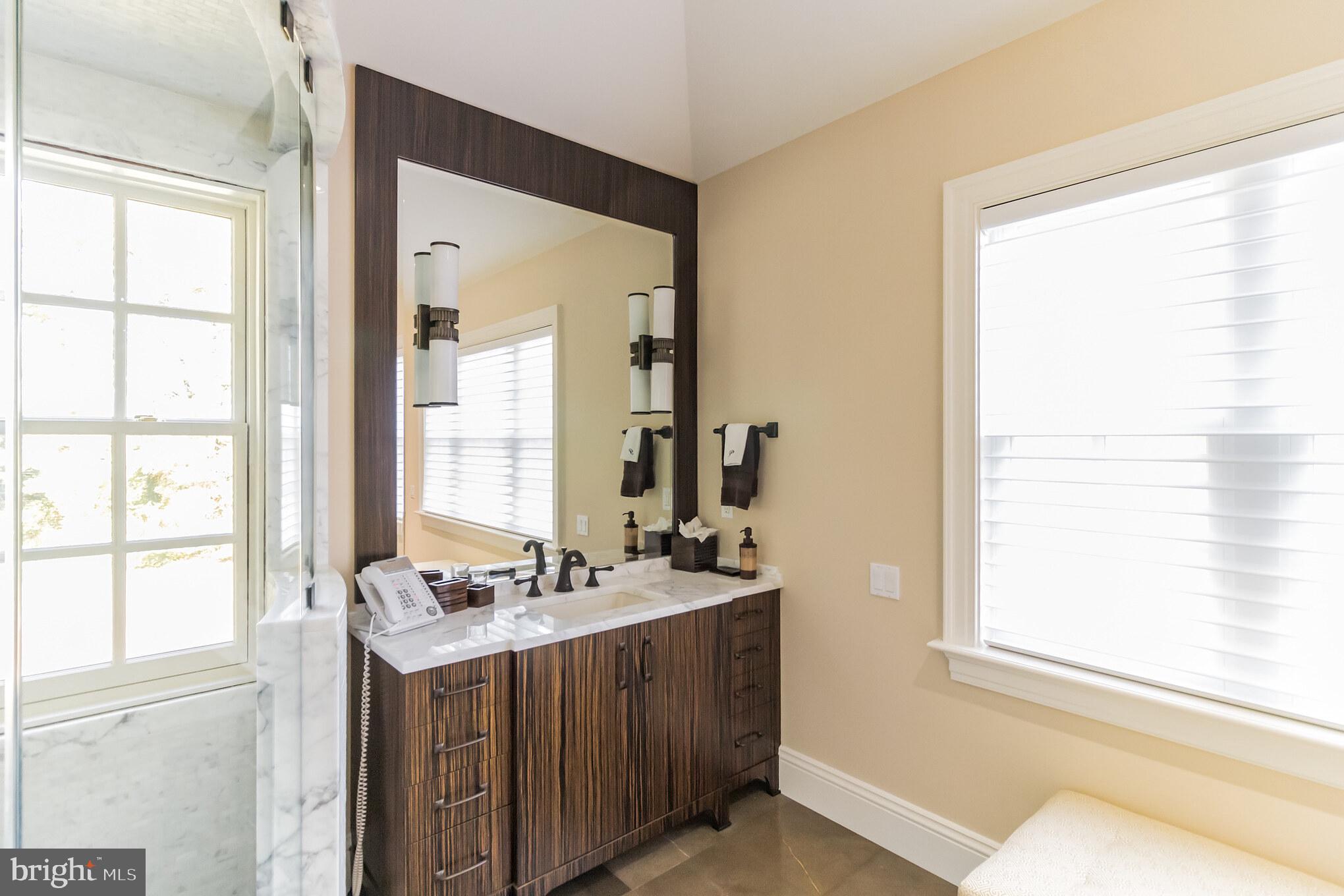 1911 Stone Ridge Lane Villanova, PA 19085 - Photo 30 of 32 a bathroom with a sink vanity and a mirror