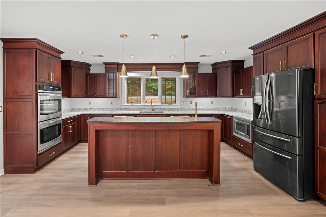309 Woodland Way Clemson, SC 29631 - Photo 10 of 43 This spacious kitchen offers a large island, generous cabinetry, and ample counter space, perfect for culinary endeavors.