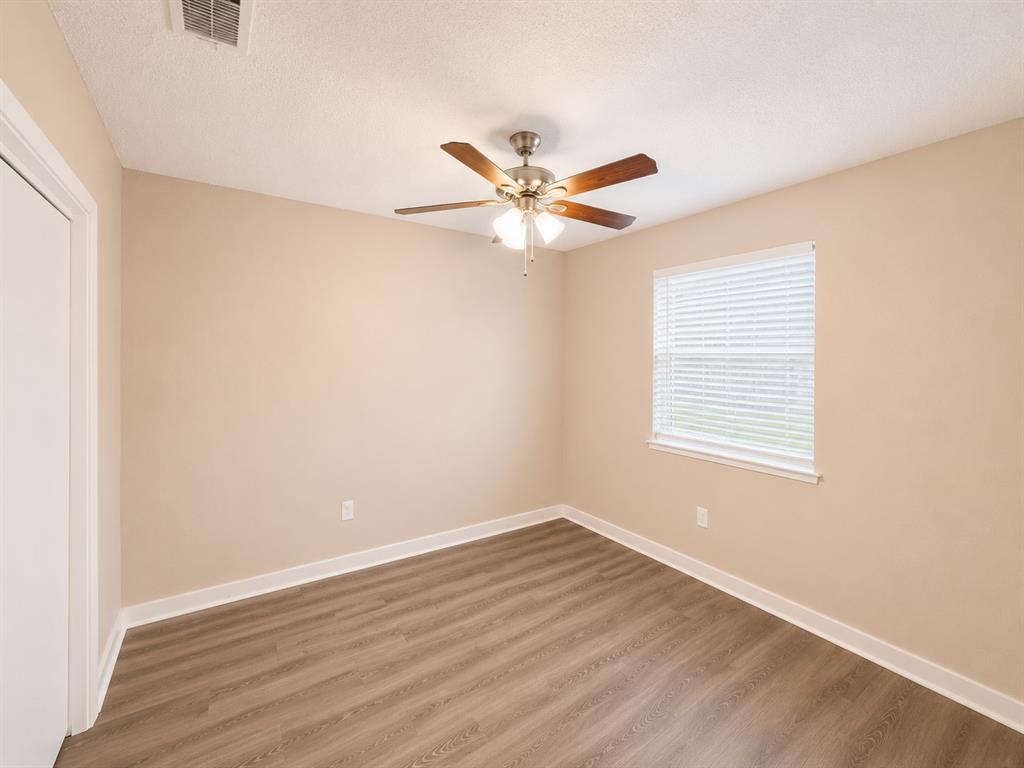 1231 Rutherford Drive Mesquite, TX 75149 - Photo 12 of 29 an empty room with a window and a fan