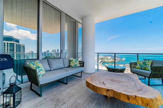 a kitchen with white cabinets and refrigerator