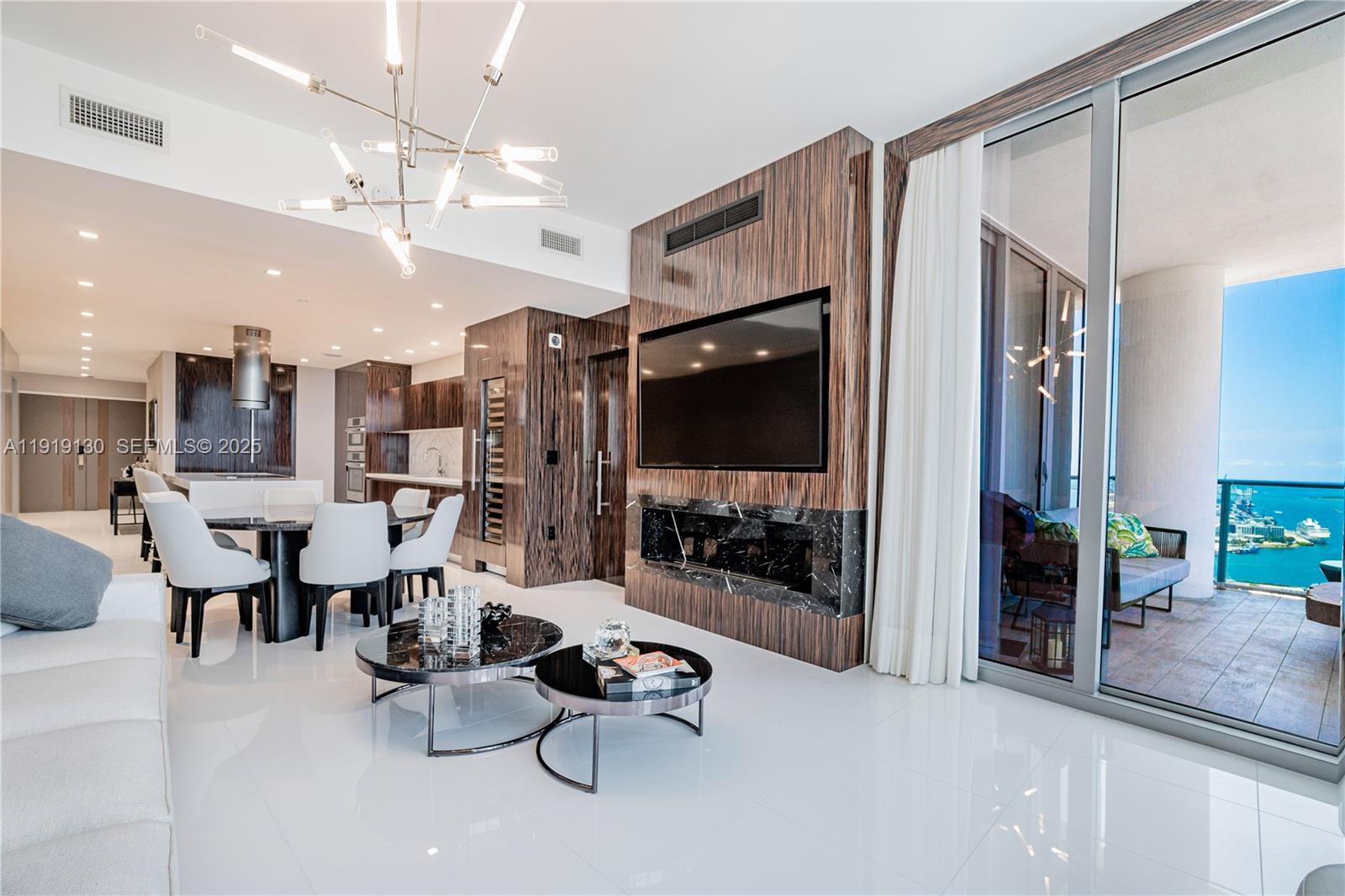 851 Northeast 1st Avenue, Unit 3511 Miami, FL 33132 - Photo 14 of 53 a living room with couches and kitchen view with wooden floor