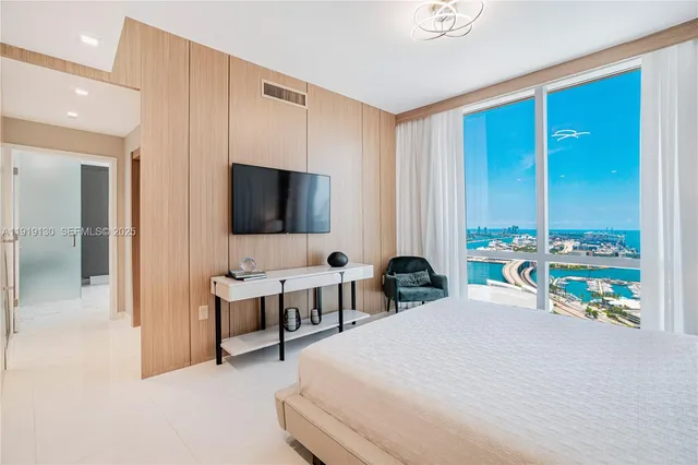a bathroom with a bathtub a double vanity sink and mirror
