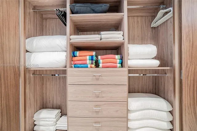 a kitchen with a refrigerator and white cabinets
