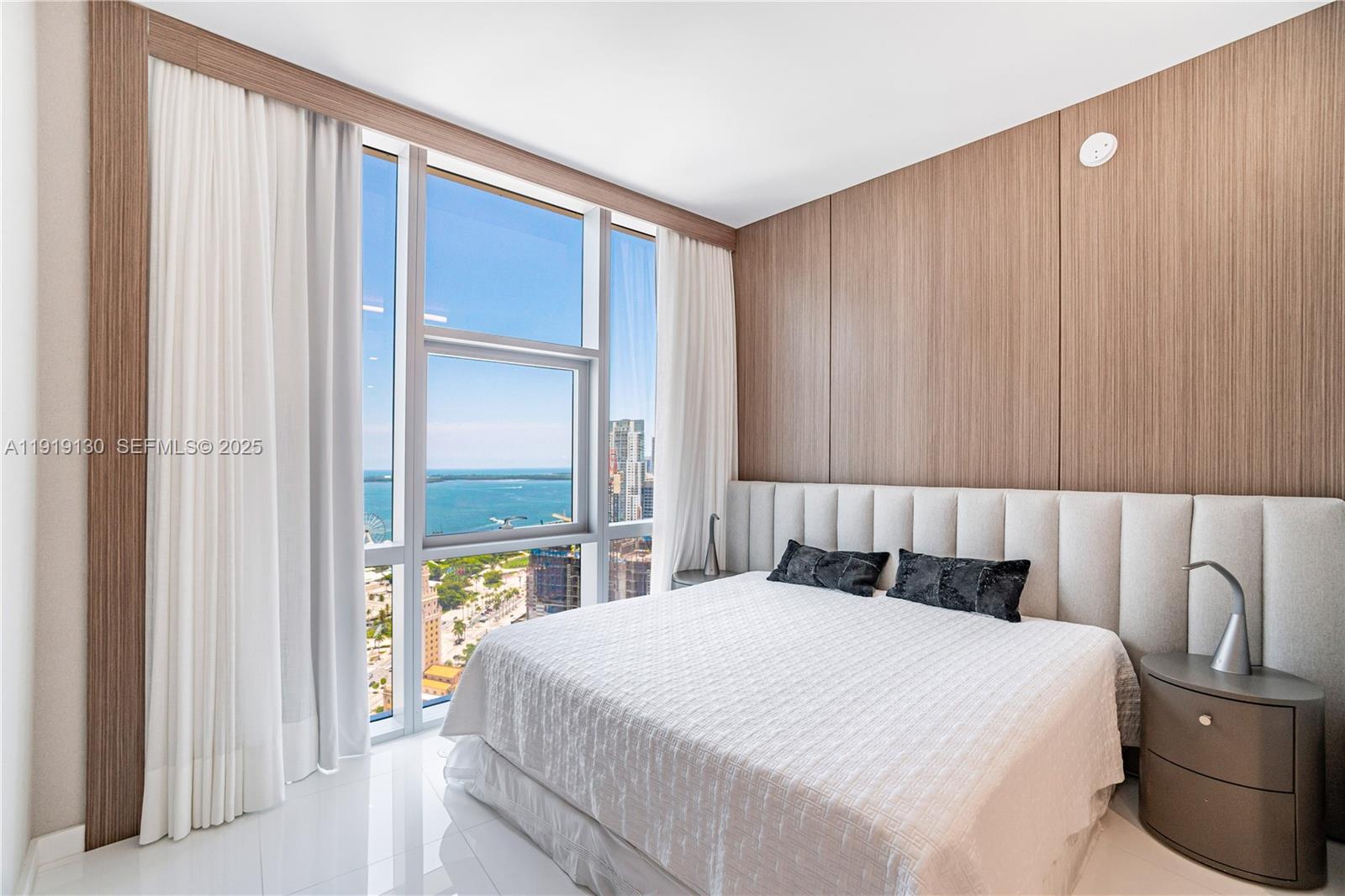 851 Northeast 1st Avenue, Unit 3511 Miami, FL 33132 - Photo 21 of 53 a bedroom with a bed and a window