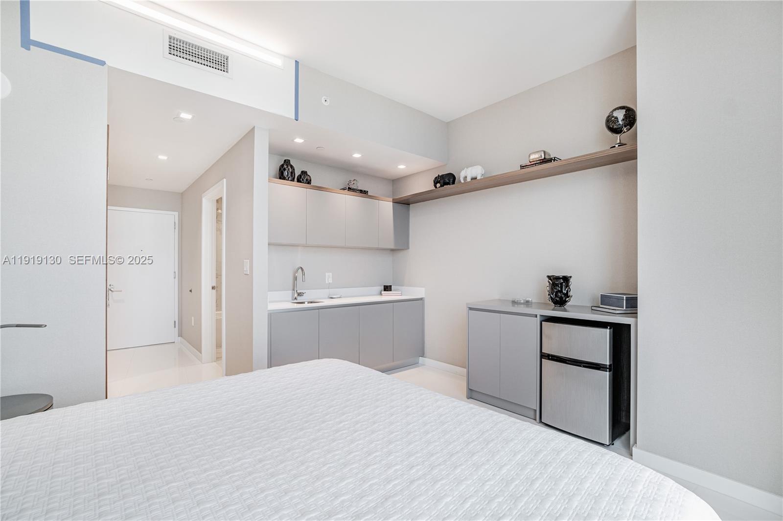851 Northeast 1st Avenue, Unit 3511 Miami, FL 33132 - Photo 22 of 53 a kitchen with a refrigerator and white cabinets